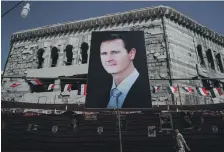  ?? Reuters ?? A banner depicts Syrian president Bashar Al Assad in Douma