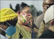  ?? ?? CARSON resident Briana Vega holds her nose during the news conference. The odor should be much weaker by the weekend, an L.A. County official said.