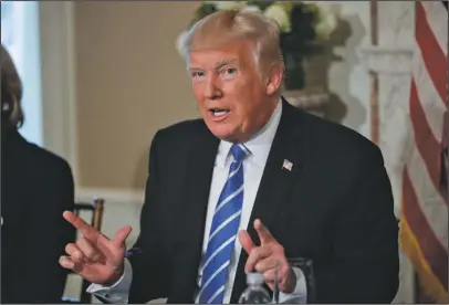  ?? The Associated Press ?? TRUMP: President Donald Trump gestures as he answers a question regarding the ongoing situation in North Korea on Friday at Trump National Golf Club in Bedminster, N.J.