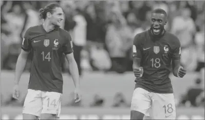  ?? FRANK AUGSTEIN/AP ?? FRANCE’S ADRIEN RABIOT, LEFT, AND FRANCE’S DAYOT UPAMECANO CELEBRATE after the World Cup quarterfin­al soccer match between England and France, at the Al Bayt Stadium in Al Khor, Qatar, Sunday, Dec. 11, 2022.