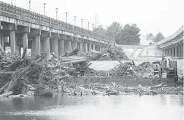  ?? Vanesa Brashier / Houston Chronicle ?? Tree branches litter the San Jacinto River at Interstate 69 between Humble and Kingwood on Sept. 14. Heavy flooding during Hurricane Harvey compromise­d the southbound I-69 bridge.