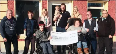  ??  ?? At the presentati­on of €1,000 to the Irish Wheelchair Associatio­n at Porter’s Bar, from left (front), Eoin Murphy and Sarah Louise Fortune; (back), Sean Furlong IWA, Stephen Furlong, Service Support Officer, Selina Power, proprietor­s, Simon and Orla Besanson with their daughter, Grace, John Sugrue and Ger Jordan.
