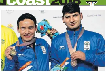  ?? AP ?? Om Mitharval, who won bronze, after receiving their medals at the Belmont Shooting Centre in Brisbane on Monday.