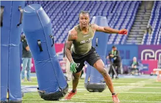  ?? Michael Conroy/Associated Press ?? Florida A&M defensive lineman Isaiah Land runs a drill at the NFL scouting combine in Indianapol­is on Thursday.