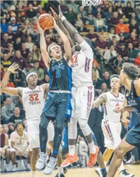  ??  ?? Duke guard Luke Kennard goes up for a basket against Virginia Tech guard Ty Outlaw during the first half of Saturday’s game. Tech won 89-75. Don Petersen,AP