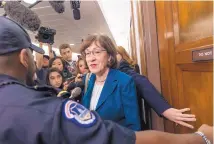  ?? J. SCOTT APPLEWHITE/ASSOCIATED PRESS ?? Sen. Susan Collins, R-Maine, is escorted by U.S. Capitol Police as she is met by cameras and reporters on Capitol Hill in Washington on Wednesday.