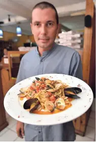  ??  ?? Chef Pedroli knows how to please your taste buds with the delicious signature meal linguine with a medley of seafood blend.