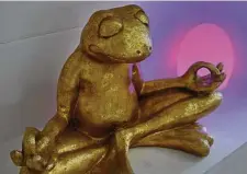  ?? Bonnie Jo Mount/Washington Post ?? A meditating frog sculpture sets a Zen mood.