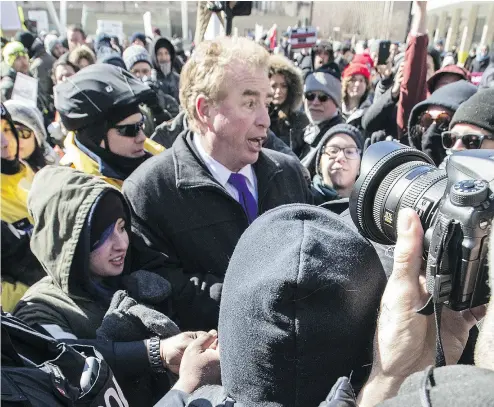  ?? TOP: CRAIG ROBERTSON / TORONTO SUN / POSTMEDIA NETWORK, BELOW: REBEL MEDIA ?? Rebel news reporter David Menzies is surrounded by anti-Islamophob­ia protesters yelling “fake news” at Toronto’s city hall in March. Below, Tommy Robinson is The Rebel’s chief U.K. contributo­r.