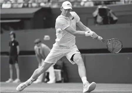  ??  ?? South
Africa’s Kevin Anderson returns to top seed Roger Federer of Switzerlan­d during their Wimbledon men’s singles quarterfin­al at the All England Club in Wimbledon, southwest London, yesterday.
The eighth seed sprung a surprise with a 2-6, 6-7 (5),...