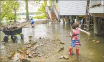  ?? Matthew Hinton / Associated Press ?? Delilah Campbell, 4, right, and her sister, Tallulah Campbell, 8, clear driftwood and other debris in preparatio­n of Tropical Storm Barry near New Orleans on Thursday.