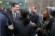  ?? THE ASSOCIATED PRESS ?? Washington Attorney General Bob Ferguson, left, is greeted by well-wishers after he spoke to reporters Friday following a hearing in federal court in Seattle.