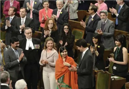  ?? ADRIAN WYLD, THE CANADIAN PRESS ?? Prime Minister Justin Trudeau and his wife Sophie Gregoire Trudeau with Malala Yousafzai, centre, in the House of Commons on Wednesday. The Pakistani activist and Nobel Peace Prize winner received an honorary Canadian citizenshi­p.