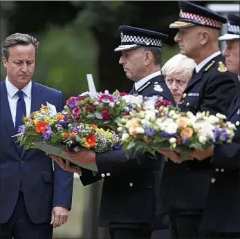  ??  ?? Paying respect: David Cameron, Boris Johnson and senior police officers at the 7/7 memorial this morning