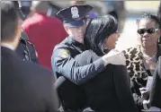  ??  ?? Officer Kyle Craig, Terence Olridge’s partner, comforts Olridge’s fiancee, Shaleda Rozier. Craig described his partner as a “humble” man who loved his family and job.