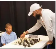  ?? (Arkansas Democrat-Gazette/Cary Jenkins) ?? Derrius Lambert, a member of the CPR Chess Club, watches as chess coach Joe White explains why one move is better than another.