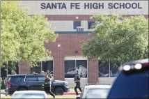  ?? STEVE GONZALES / HOUSTON CHRONICLE ?? Emergency responders react to an active shooter situation in front of Santa Fe High School on Friday.