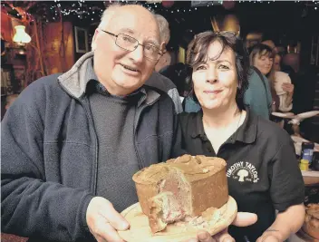  ??  ?? The winner’s dad Peter Bland picks up the accolade for son Martin, who was unable to attend, with Leeds Arms landlady Marie Wood. Pictures by Richard Ponter