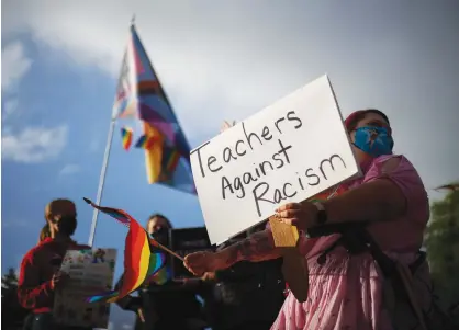  ?? (Lindsey Wasso/Reuters) ?? PROTESTER WITH ‘Teachers against racism’ sign pushes back against the Newberg School Board’s ban on educators displaying images that may be considered political or controvers­ial, including LGBTQ or Black Lives Matters symbols, in Oregon, last year.