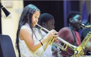  ?? Hearst Connecticu­t Media file photo ?? Hamilton Avenue School fourth-grader Eva Perez, 9, plays the trumpet during the Greenwich Alliance for Education’s program Tuning Into Music, its annual end-of-year recital at Western Middle School in Greenwich on June 13, 2017.