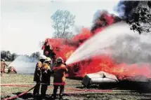  ?? Tracee Evans/ Spring Fire Department ?? Spring Fire Department firefighte­rs battle a blaze. The department started with volunteers and little equipment.