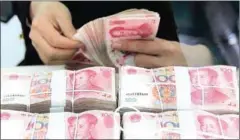  ?? XINHUA NEWS AGENCY ?? A staff member counts yuan banknotes at a bank in Linyi of eastern China’s Shandong province.