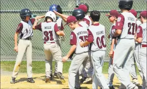  ?? Christian Abraham / Hearst Connecticu­t Media ?? Teammates surround North Haven's Jaden Wells (31) after he hit a grand slam against Darien on Saturday.