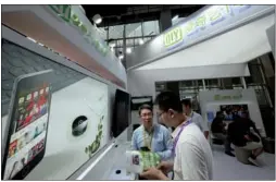  ?? PROVIDED TO CHINA DAILY ?? A visitor learns about the products of iQiyi Inc at its booth at the E-Surfing Smart Ecosystem Expo held in Guangzhou, Guangdong province.