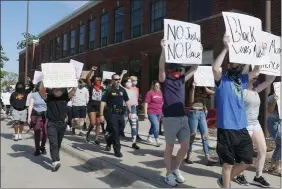  ??  ?? Protests in Michael’s hometown of Ames, Iowa. Police officers joined.