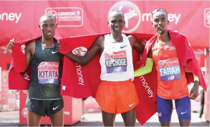  ?? Photo: AFP ?? Winner Kenya’s Eliud Kipchoge, (C), second-placed Ethiopia’s Tola Shura Kitata (L) and third-placed Britain’s Mo Farah pose after the elite men’s race of the 2018 London Marathon yesterday