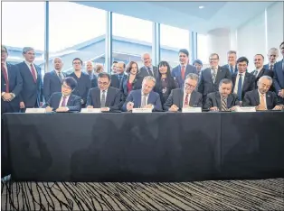  ?? CP PHOTO ?? Seated from left to right, Inkee Kim, of KOGAS, Wei Gao, of Petrochina, Maarten Wetselaar, of Shell, LNG Canada CEO Andy Calitz, Adnan Zainal Abidin, of PETRONAS, and Hidenori Takaoka, of Mitsubishi Corporatio­n, sign a final investment declaratio­n to build the LNG Canada export facility in Kitimat, during a news conference in Vancouver on Tuesday.