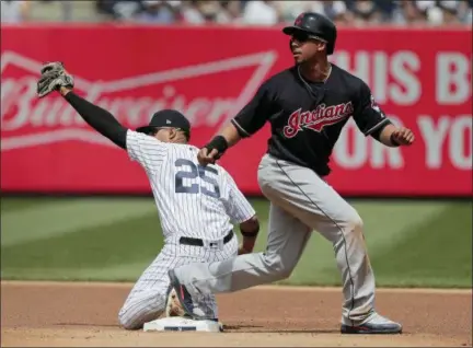  ?? JULIE JACOBSON — THE ASSOCIATED PRESS ?? New York Yankees second baseman Gleyber Torres (25) holds up the ball as Cleveland Indians’ Michael Brantley looks for the call on a force out at second base during the fourth inning of a baseball game, Saturday in New York. Brantley was out at second.