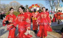  ?? ?? Top: Internatio­nal performers in traditiona­l Chinese clothing, including one dressed as the God of Wealth, add an East-West touch to festive celebratio­ns at Beijing World Park on Feb 14. GENG FEIFEI /
CHINA DAILY Above: The temple fair at Temple of Earth park is crowded with visitors during the Spring Festival holiday. ZHU XINGXIN / CHINA DAILY