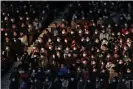  ??  ?? Fans wear face masks at a football match in Kobe, Japan. Photograph: JIJI PRESS/AFP via Getty Images