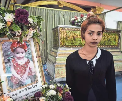  ?? LILLIAN SUWANRUMPH­A, AFP/GETTY IMAGES ?? Jiranuch Trirat’s 11-month-old daughter, Natalie, was hanged by the girl’s father last month in Phuket, Thailand, and a video of the killing was posted on Facebook Live. Natalie’s father killed himself.