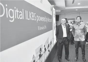  ?? — Bernama photo ?? Minister ofYouth and Sports Khairy Jamaluddin (right) and K Raman are seen launching the ILKBS at Microsoft Malaysia’s headquarte­rs. The Digital ILKBS initiative aims to develop future-ready human capital in response to the shifting global digital...