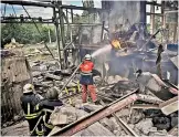  ?? — AFP ?? Firemen extinguish a fire at a Gypsum Manufactor­y plant after shelling in the city of Bakhmut at the eastern Ukrainian region of Donbas on Friday.