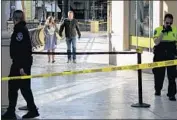  ?? Kent Nishimura Los Angeles Times ?? AN EMPLOYEE with Paper Source is escorted from the shooting scene on Saturday at the Oaks mall.