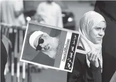  ??  ?? This 2011 file photo shows an Egyptian girl holding a portrait of cleric Sheikh Omar Abdel Rahman, during a sit-in to call for his release in front of the US Embassy in Cairo. — AFP photo