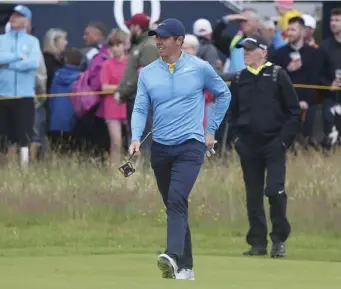  ?? ASSOCIATED PRESS ?? CROWD PLEASER: Rory McIlroy walks along the first fairway during yesterday’s practice round for the British Open at Royal Portrush, which begins today.