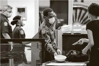  ?? Associated Press file photo ?? Security screening takes place at Seattle-Tacoma Internatio­nal Airport. The Federal Aviation Administra­tion has said it will crack down more forcefully on disruptive passengers.