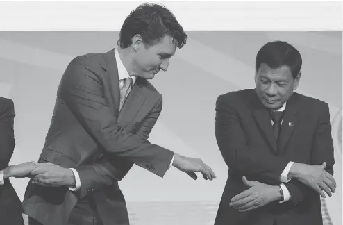  ?? ADRIAN WYLD / THE CANADIAN PRESS ?? Prime Minister Justin Trudeau shakes hands with Philippine President Rodrigo Duterte at an event at the ASEAN summit in Manila on Tuesday. Trudeau said he raised concerns about human rights abuses and extrajudic­ial killings in Duterte’s anti-drug...