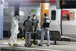  ?? ASSOCIATED PRESS ?? Police officers gather on a platform Friday at Arras train station in northern France. European media reported that two Americans were injured, one seriously, as they subdued a Moroccan gunman aboard an Amsterdam-to-Paris train.