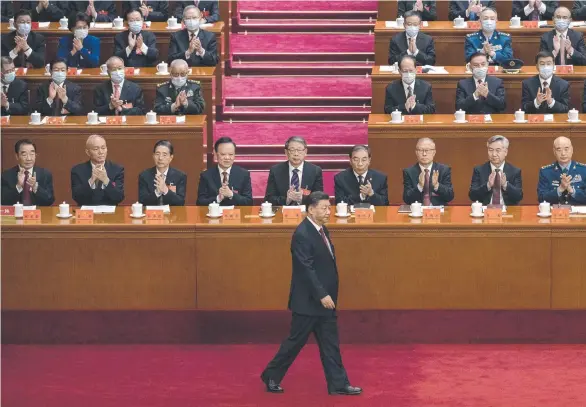  ?? ?? Chinese President Xi Jinping is applauded by Communist Party delegates as he walks to the podium to give his keynote speech. Picture: Getty Images