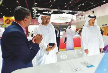  ?? Virendra Saklani/Gulf News ?? Majid Saif Al Ghurair, Chairman of the Dubai Chamber of Commerce and Industry with Helal Saeed Al Merri, director-general of the DWTCA and Dubai Department of Tourism and Commerce Marketing take a tour after opening the Gitex Shopper yesterday.