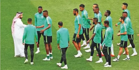  ?? Reuters ?? Saudi Arabia’s sports minister Turki Al Shaikh greets players during a team training session at the Luzhniki Stadium in Moscow, ahead of their opening match against Russia today.