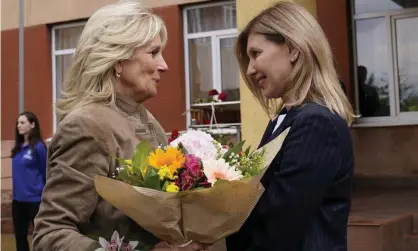  ?? ?? Jill Biden greets Olena Zelenskiy, Ukrain’s first lady, outside of School 6, in Uzhhorod, Ukraine, on Sunday. Photograph: Susan Walsh/AP