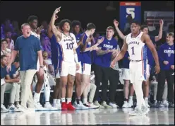  ?? Bahamas Visual Services via AP ?? Kansas coach Bill Self (left) and members of his team celebrate during an NCAA college basketball game against N.C. State on Wednesday at the Battle 4 Atlantis at Paradise Island, Bahamas. Kansas won 80-74.