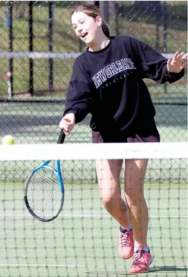  ?? ?? Josie White plays a forehand as she runs towards the nets.