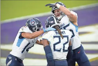  ?? Ap-nick Wass ?? Tennessee Titans running back Derrick Henry (22) celebrates his game-winning touchdown with wide receiver Kalif Raymond, left, and tight end Anthony Firkser during overtime of an NFL football game against the Baltimore Ravens, Sunday, Nov. 22, 2020, in Baltimore. The Titans won 30-24 in overtime.